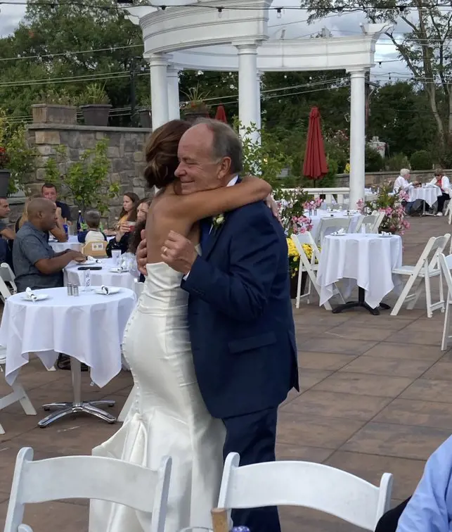 Dianna Russini hugging her father Rick Russini on her wedding day.