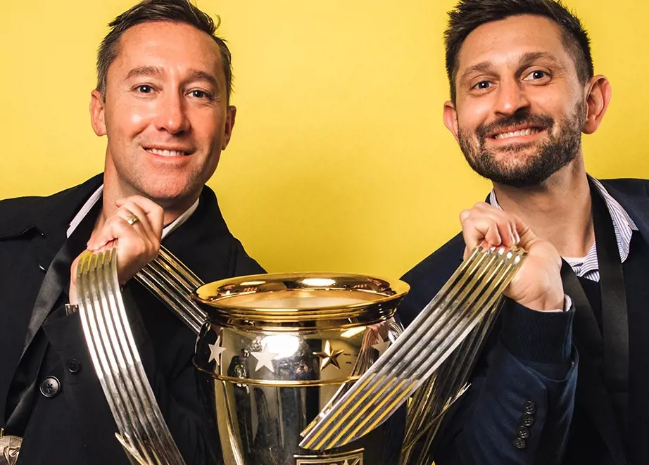 Caleb Porter with  Tim Bezbatchenko sharing trophy and striking pose for El Crew on Jan 5, 2021.