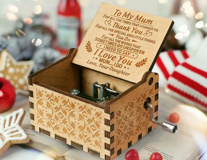 A music box gift with a custom message carved on the lid from a daughter to her mother. 