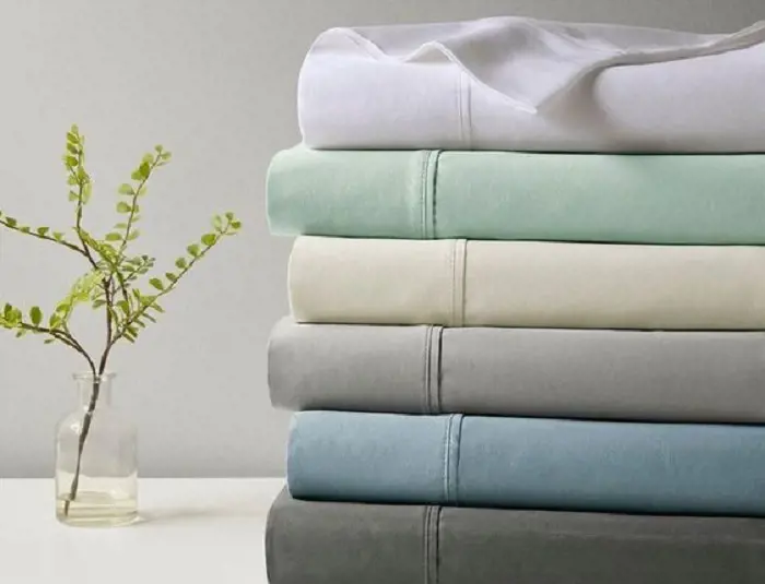 A stack of Temperature-regulating sheets in a soothing color pallet. 