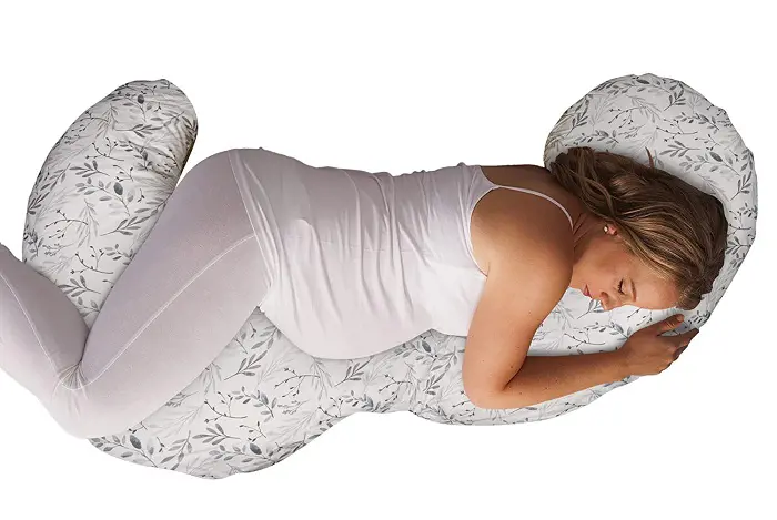 A pregnant lady having a comfortable sleep with her belly supported by Total Body Pregnancy Pillow. 