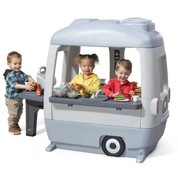 Toddlers have fun playing with an adventure camper playhouse