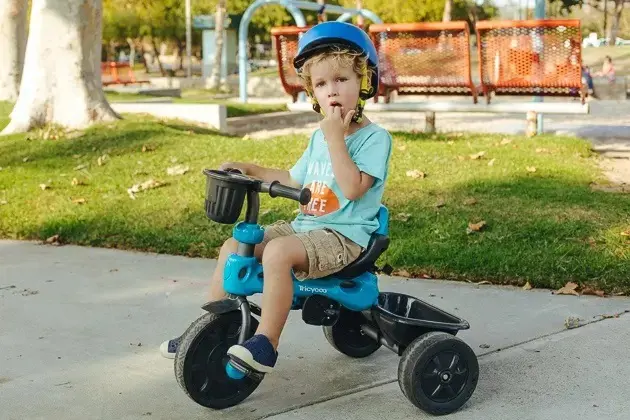 Child enjoys riding a tricycle in 2022