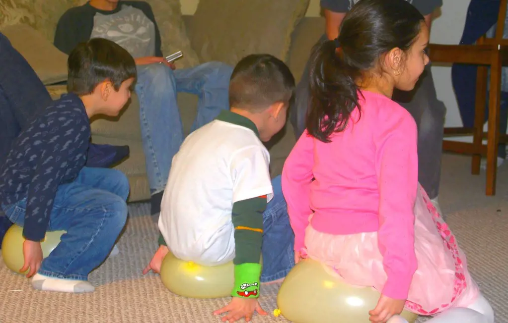 Children excitedly participate in Pop the Balloon