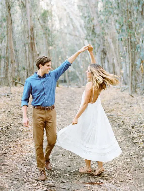 Couple in love dance with each other in the woods