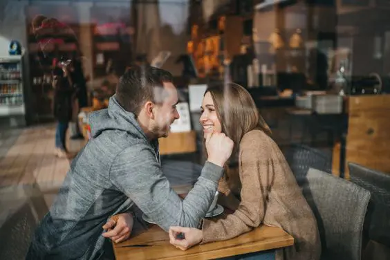 Couple lost in each other's eyes as they spend some quality time in a cafe