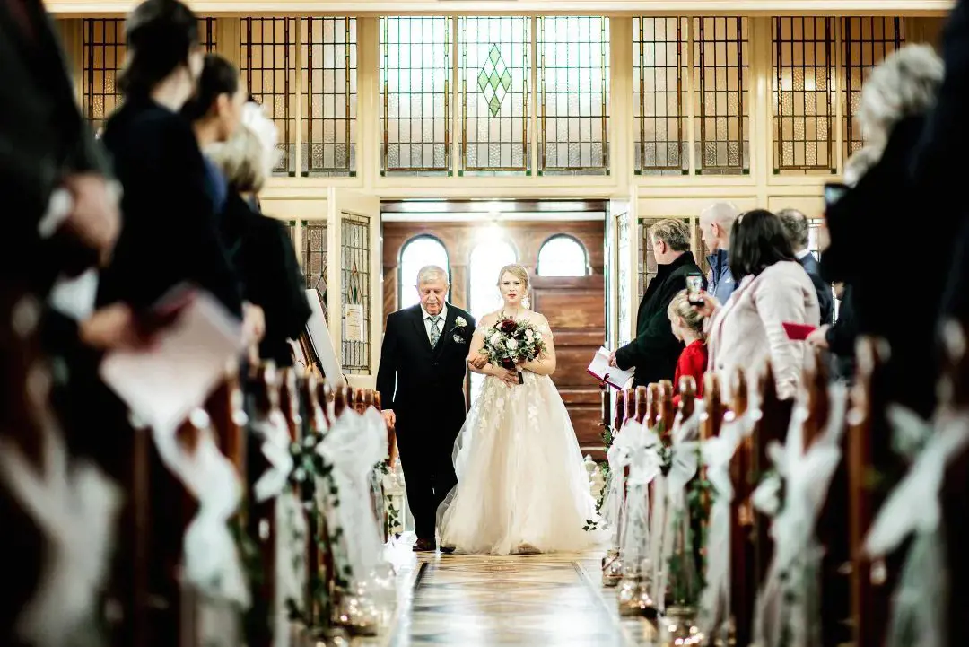 A father walks her daughter down the aisle