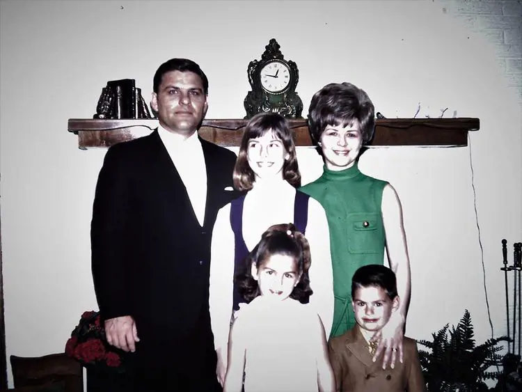 Terri, Kellie and John with their parents as they take a family picture when they were young