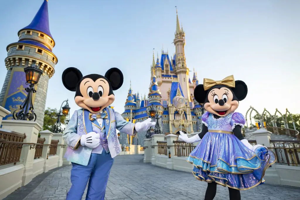 Staff dressed up as Mickey & Minnie welcome guests at the Disney World Park in Florida