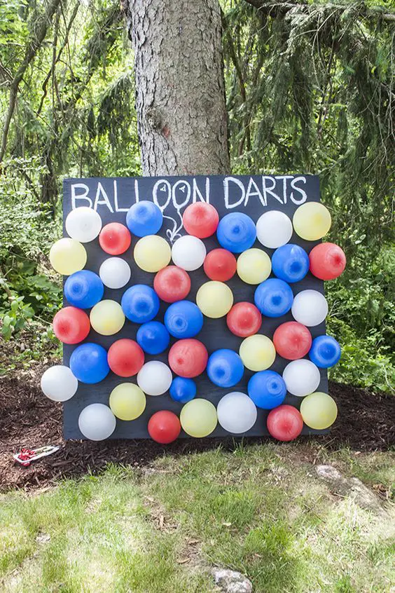 Pop some balloons with darts and say the prayers out loud. (Photo By: Maggie Smoller)