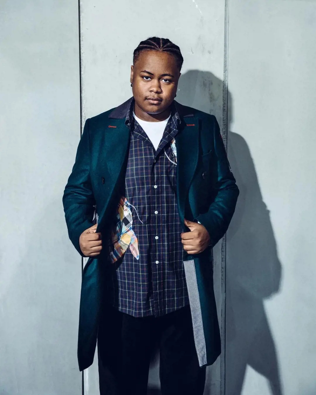 shamon attired in a pattered shirt anf long coat for the LA Times Magazize