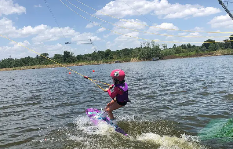 A little girl enjoys cable waterboarding at Elite Cable Park during her spring break.