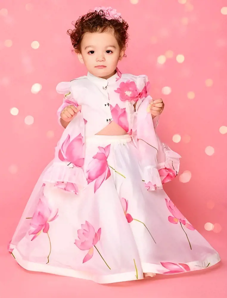 The little girl looks beautiful in her elegant dress with a lotus flower print