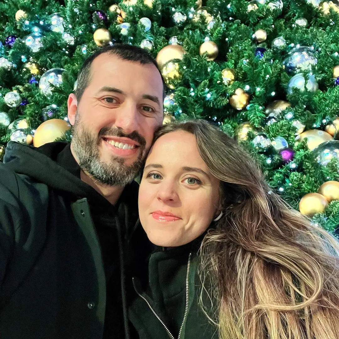 Jinger and Jeremy take a selfie in front of a Christmas Tree to celebrate the Holiday season in December 2022.