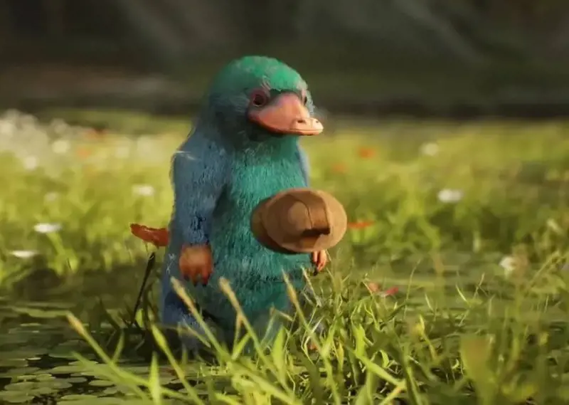 A blue and green Niffler being groomed in Hogwarts Legacy. 