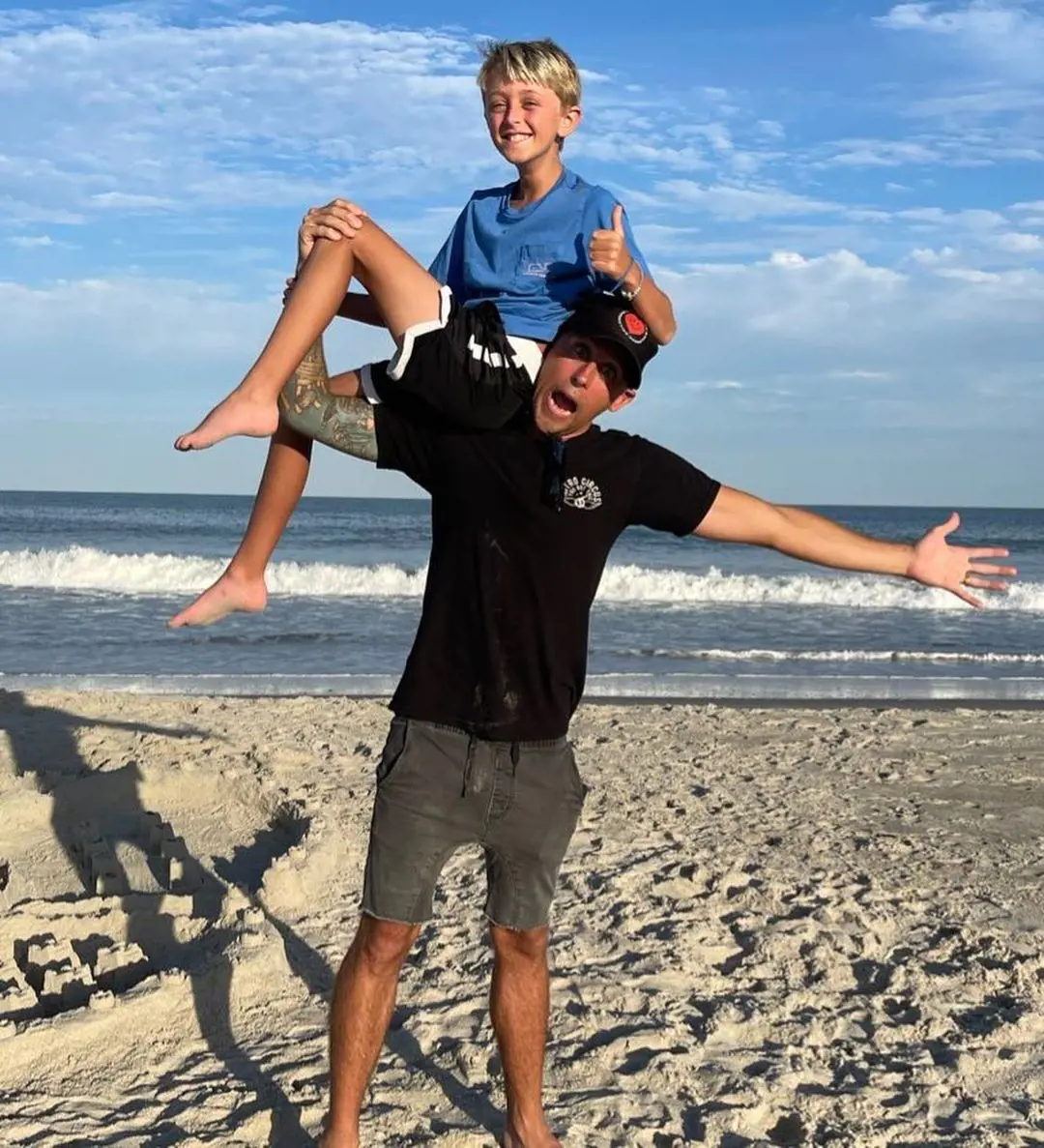 Roman and his son Kane enjoy a little father-son duo time at the beach by the sea. 