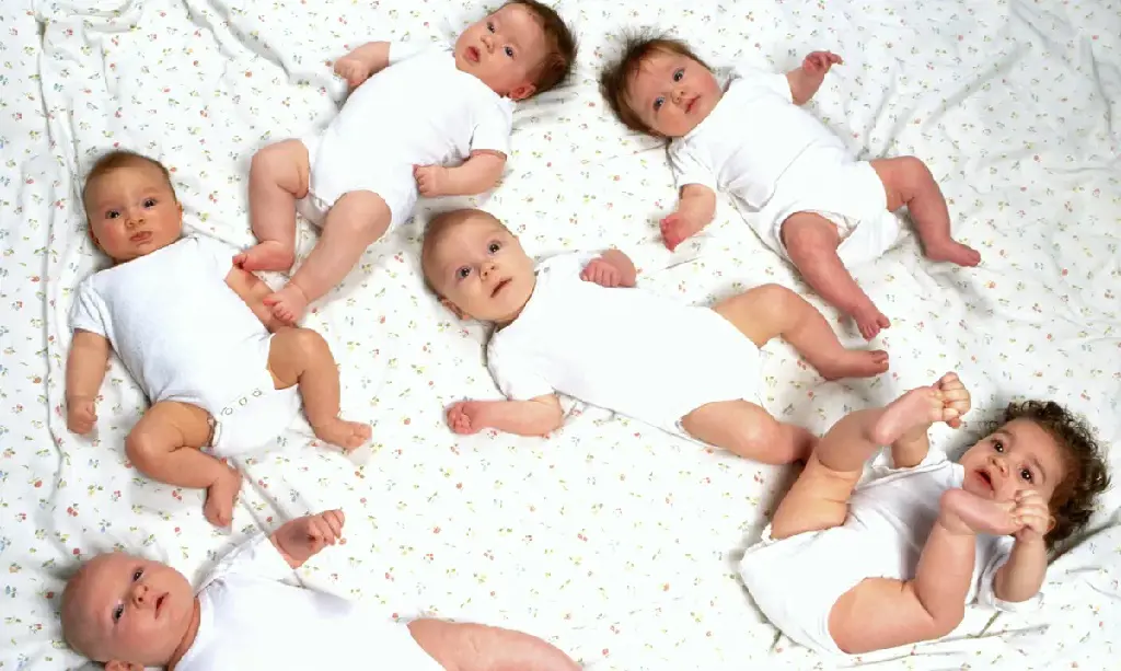 Many newborn kids in one frame