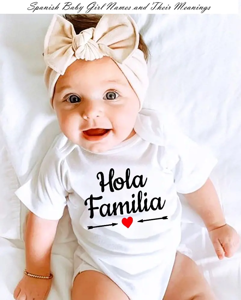 A baby girl wearing white t-shirt with the Spanish language 