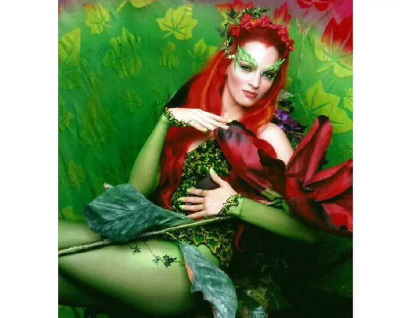 Uma Thurman portraying the character of Poison Ivy where her character is seen embedded in flower and plants. 