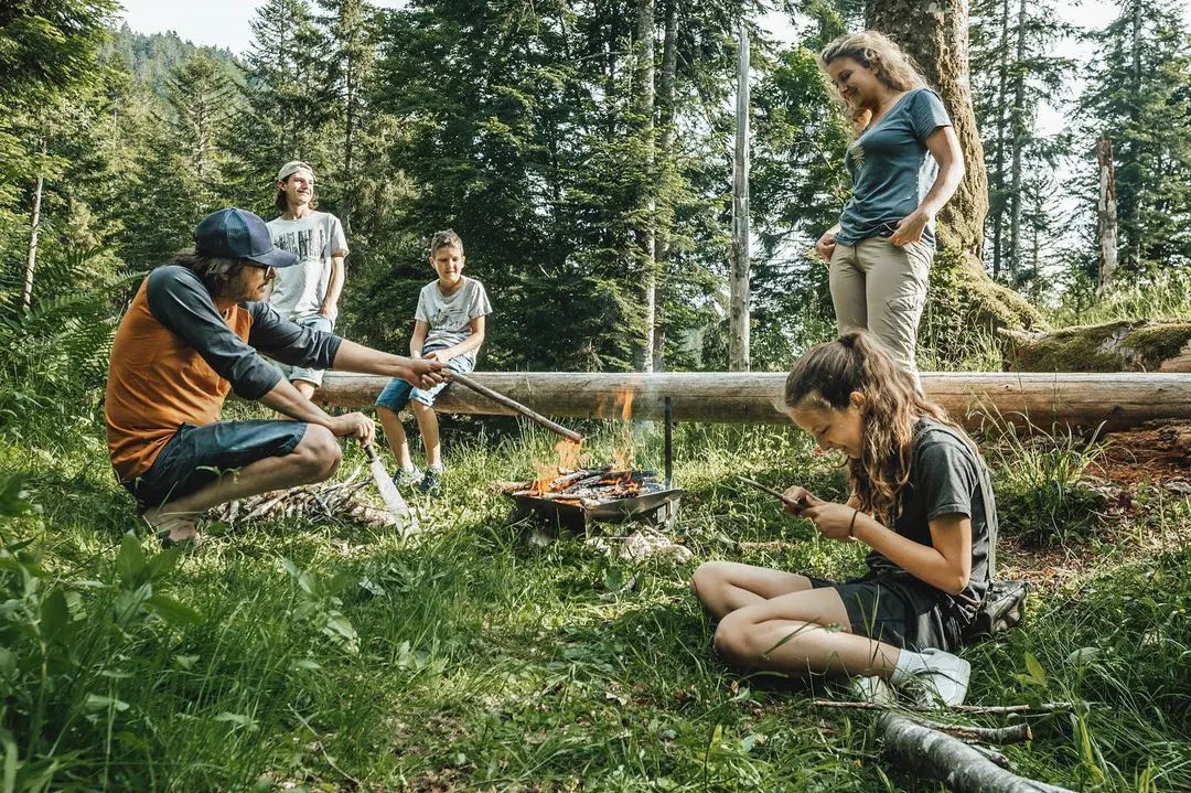 Petit Bivouac family gathers around campfire at Massif de la Chartreuse on June 20, 2021. 