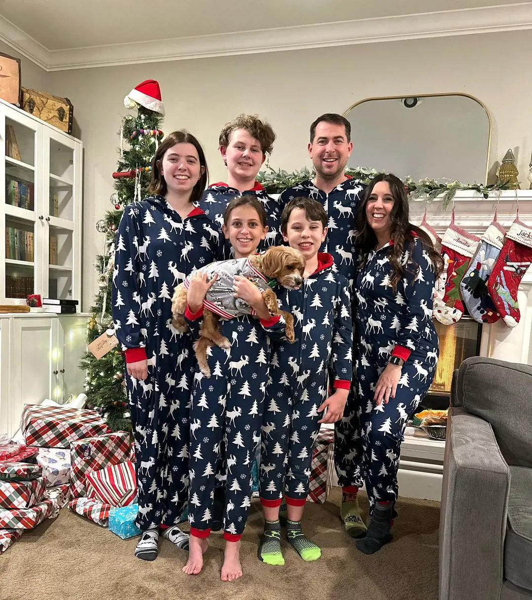 Six members of traveling family Wanderlust Crew celebrate holidays together wearing matching Pajamas on December 25, 2022.