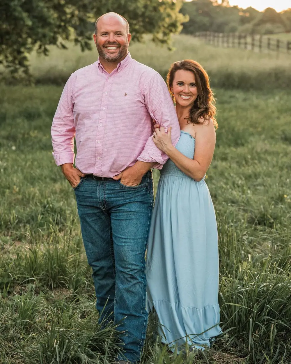 Eric and Courtney looks into the camera with smile on their faces during their couple photoshoot