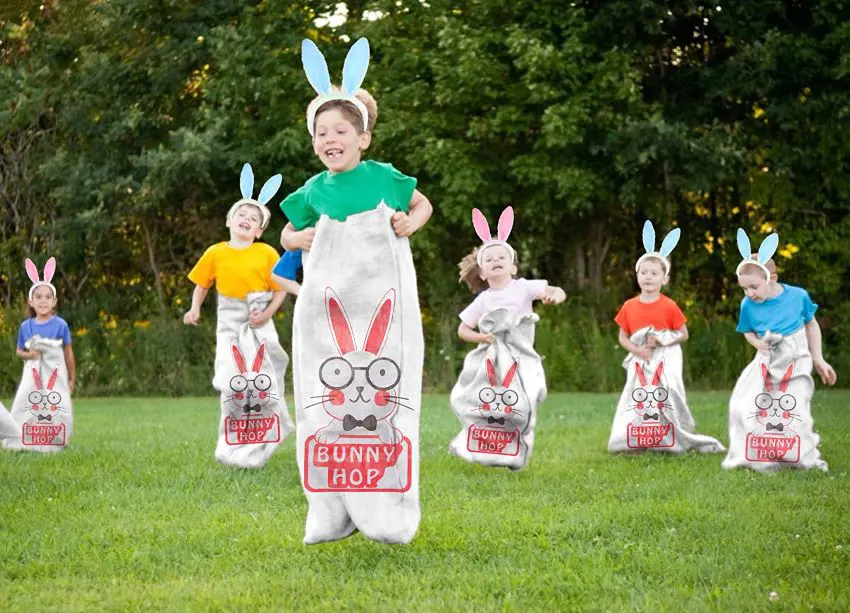 Kids enjoying a competitive bunny hop sack race in Easter