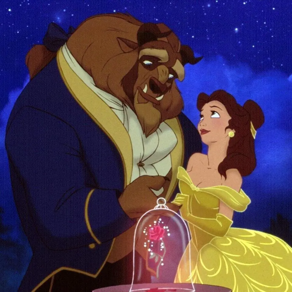 Belle and Beast embrace each other as they dance together