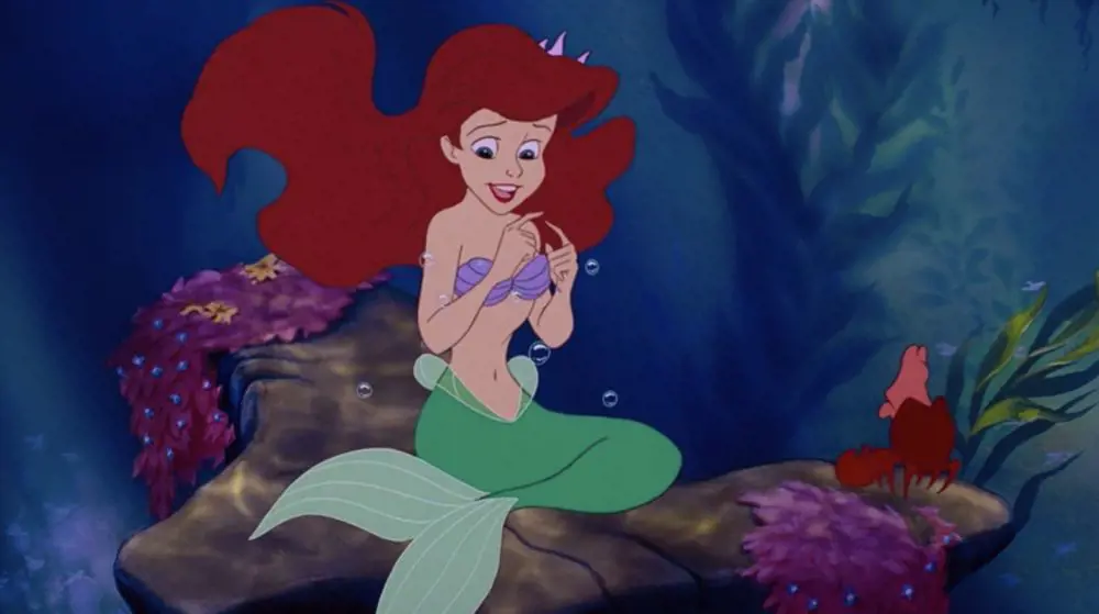 Still scene from the film The Little Mermaid where Ariel talks with Sebastian about Prince Eric 