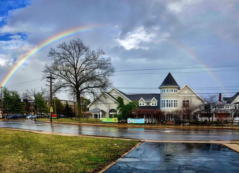 The building of The Magic House beneath a beautiful rainbow after a rainy day in Kirkwood, Missouri.